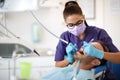 Young female dentist drilling tooth to patient Royalty Free Stock Photo