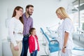 Young female dentist encourages family Royalty Free Stock Photo