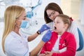 Young female dentist looks at girls teeth Royalty Free Stock Photo