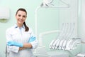 Young female dentist in white coat at workplace Royalty Free Stock Photo