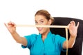 Young female dietician holding measure tape