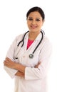 Young female doctor with arms crossed against white