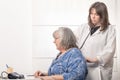 young doctor auscultating her patient& x27;s back with a stethoscope Royalty Free Stock Photo