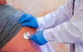 Young female doctor auscultating a patient on her back with a stethoscope Royalty Free Stock Photo