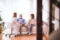 Female doctor checking blood pressure of senior man. Royalty Free Stock Photo