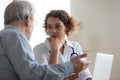 Young female doctor consult elderly patient at meeting Royalty Free Stock Photo