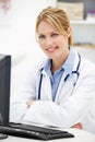 Young female doctor at desk Royalty Free Stock Photo