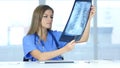 Young Female Doctor Examing X-ray of Patient, Lungs and Ribcage Royalty Free Stock Photo