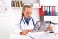 Young female doctor examining patient`s MRI or x-ray of human head brain Royalty Free Stock Photo