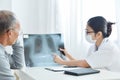 Young female doctor examining x-ray film. Royalty Free Stock Photo