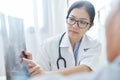 Young female doctor examining x-ray film. Royalty Free Stock Photo