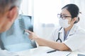 Young female doctor examining x-ray film. Royalty Free Stock Photo