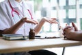 Young female doctor explains medication and treatment to patients