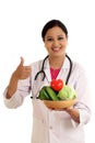 Young female doctor holding bowl of vegetables Royalty Free Stock Photo