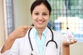 Young female doctor holding a piggy bank Royalty Free Stock Photo