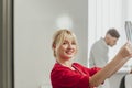 Young female doctor in hospital looking at x-ray. The other two doctors communicate in the background Royalty Free Stock Photo