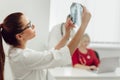 Young female doctor in hospital looking at x-ray. The other two doctors communicate in the background Royalty Free Stock Photo