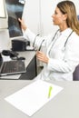 Young female doctor or intern looking at x ray image at her off Royalty Free Stock Photo