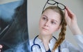 Young female doctor looking at x-ray of cervical spine, medicine concept Royalty Free Stock Photo