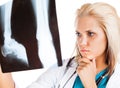 Young female doctor looking at X-ray picture Royalty Free Stock Photo