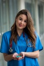 Young female doctor in in a medical equipment  holds green  pills Royalty Free Stock Photo