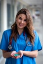 Young female doctor in in a medical equipment  holds green  pills Royalty Free Stock Photo