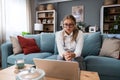 Young female doctor medical worker working from home sitting on sofa having video call with nervous sick patient listening and