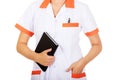 Young female doctor or nurse holding black notes Royalty Free Stock Photo