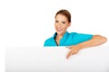 Young female doctor or nurse holding empty banner Royalty Free Stock Photo