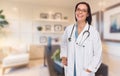 Young Female Doctor or Nurse Standing in Her Office Royalty Free Stock Photo