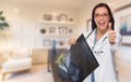 Young Female Doctor or Nurse with Thumbs Up Standing in Office H Royalty Free Stock Photo