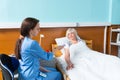 Young female doctor or nurse in uniform is giving pills to her p Royalty Free Stock Photo