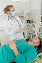 Young female doctor preparing syringe for male patient