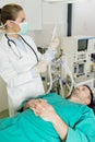 Young female doctor preparing syringe for male patient