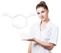 Young female doctor presents chemical formula.