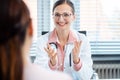 Young female doctor seeing woman patient