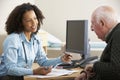 Young female Doctor with senior male patient Royalty Free Stock Photo