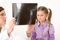 Young female doctor show x-ray to child Royalty Free Stock Photo