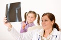 Young female doctor show x-ray to child Royalty Free Stock Photo