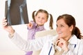 Young female doctor show x-ray to child Royalty Free Stock Photo