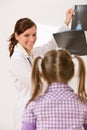 Young female doctor show x-ray to child Royalty Free Stock Photo