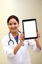 Young female doctor showing blank white screen tablet computer Royalty Free Stock Photo