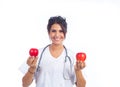 Young female doctor showing two beautiful red apples Royalty Free Stock Photo