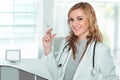 Young female doctor smiling with a syringe in her hand Royalty Free Stock Photo