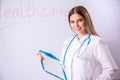 The young female doctor standing in front of the white board Royalty Free Stock Photo