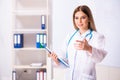 The young female doctor standing in front of the white board Royalty Free Stock Photo