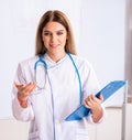 The young female doctor standing in front of the white board Royalty Free Stock Photo