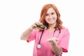 Young female doctor with stethoscope emptying bottle of pills