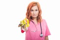 Young female doctor with stethoscope handing yellow measuring ta Royalty Free Stock Photo