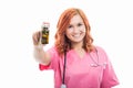 Young female doctor with stethoscope holding bottle of pills Royalty Free Stock Photo